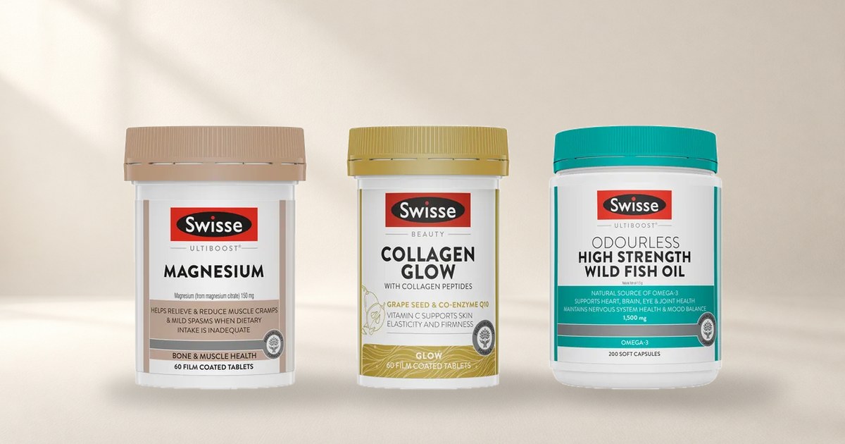 Swisse magnesium, Collagen Glow and wild fish oil bottles standing side by side on a pale studio floor